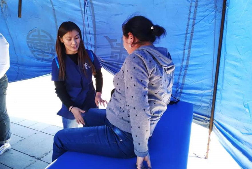 A physiotherapist treats a patient