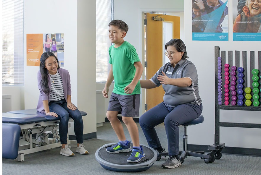 Photo showing a child receiving physiotherapy in the US